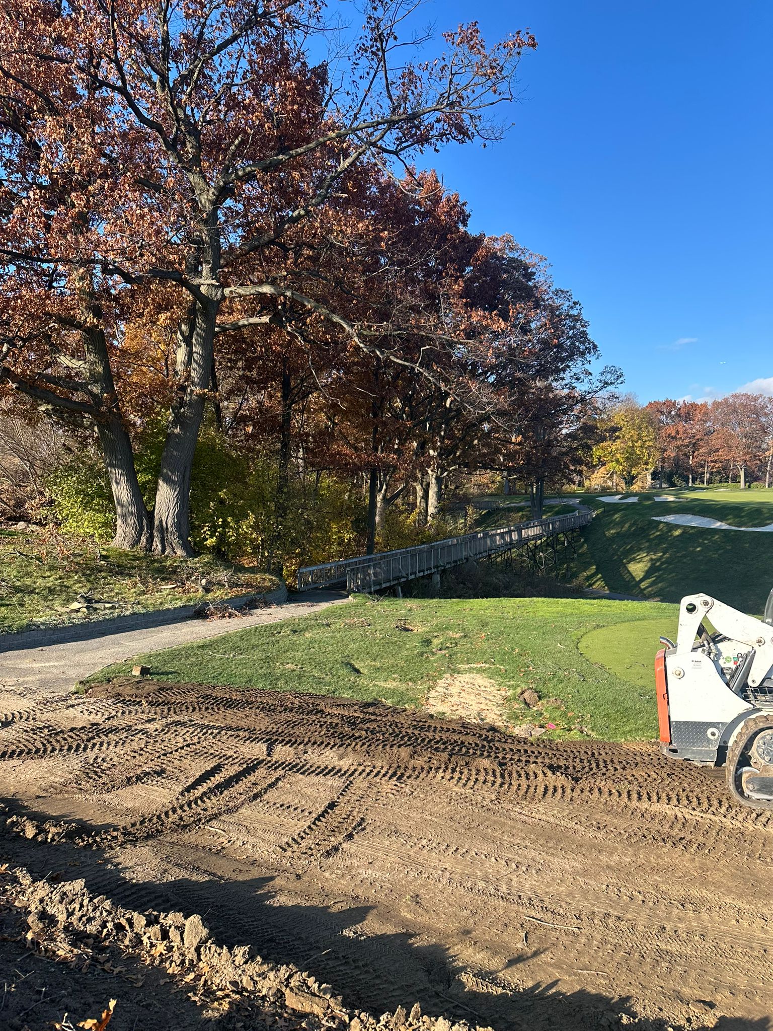 Site grading work with bobcat on golf course